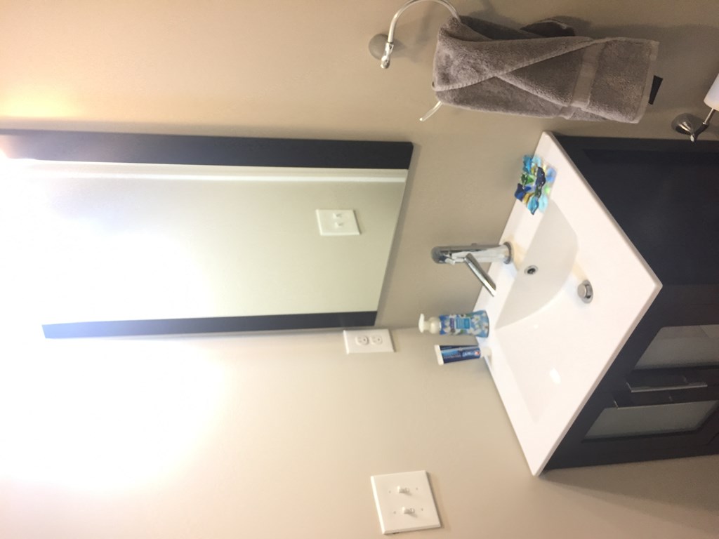 a small bathroom with a sink and a mirror