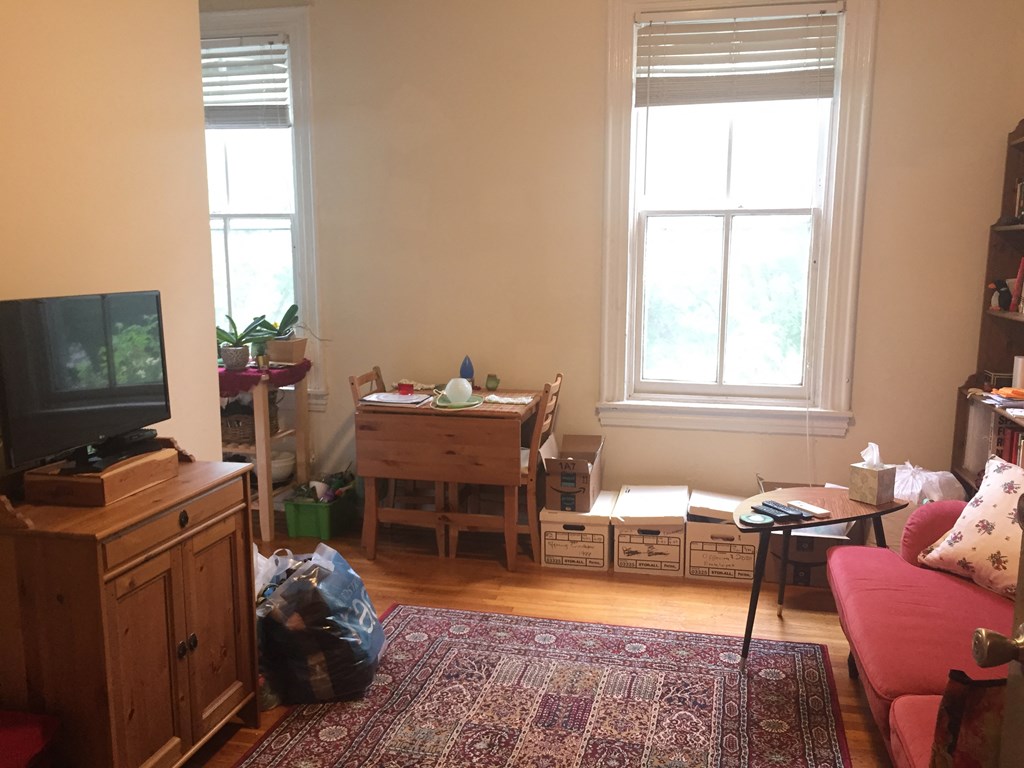 a living room filled with furniture and a tv