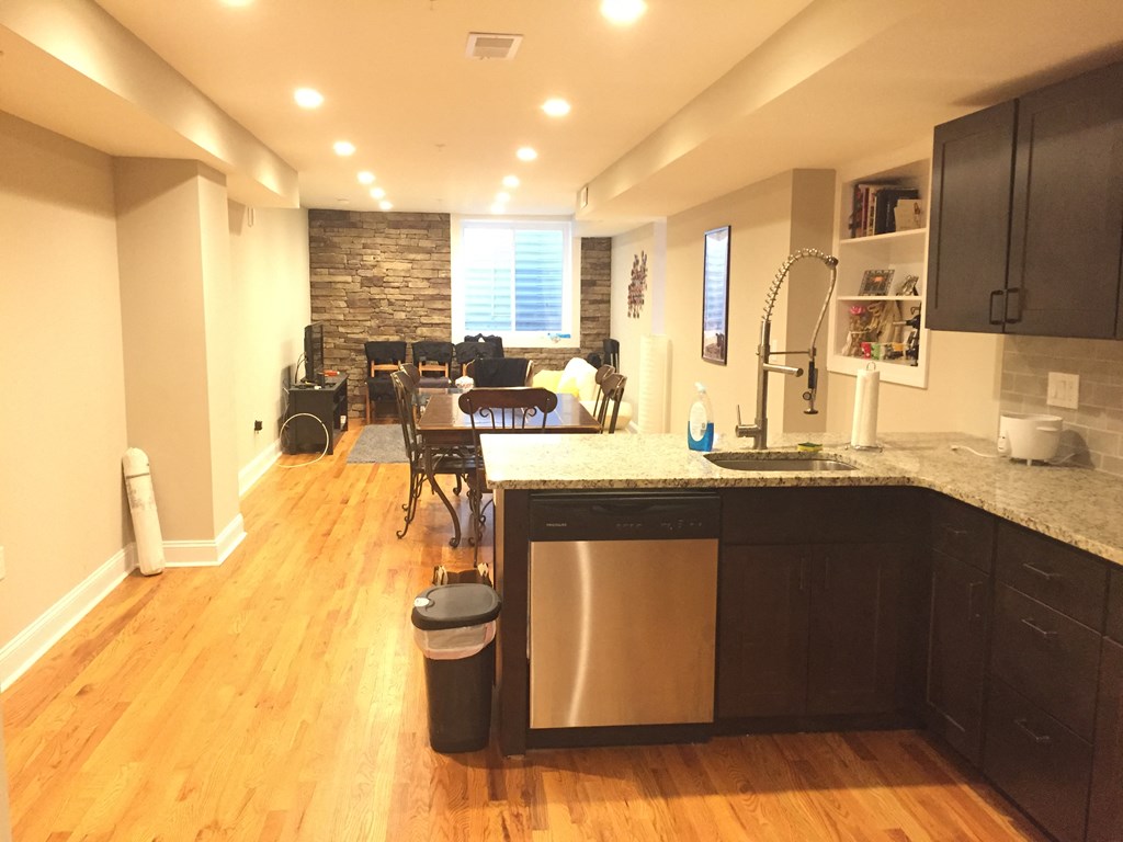 an open kitchen and living room with a dining room in the background