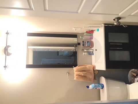 a small bathroom with a mirror and a toilet and a sink