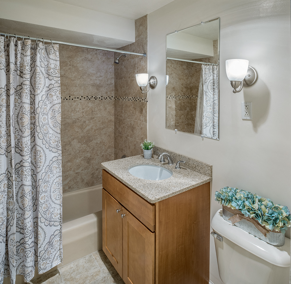 an empty bathroom with a sink toilet and shower