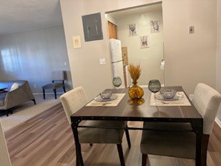A dining table with chairs and a vase on it.