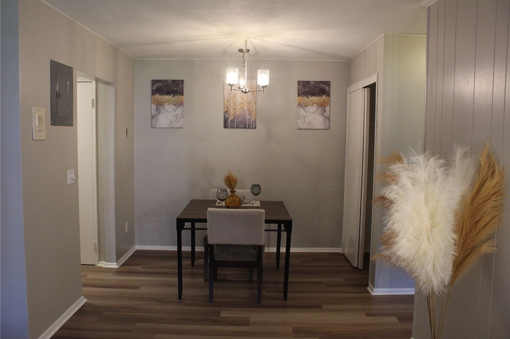 A dining room with a wooden table and chairs.