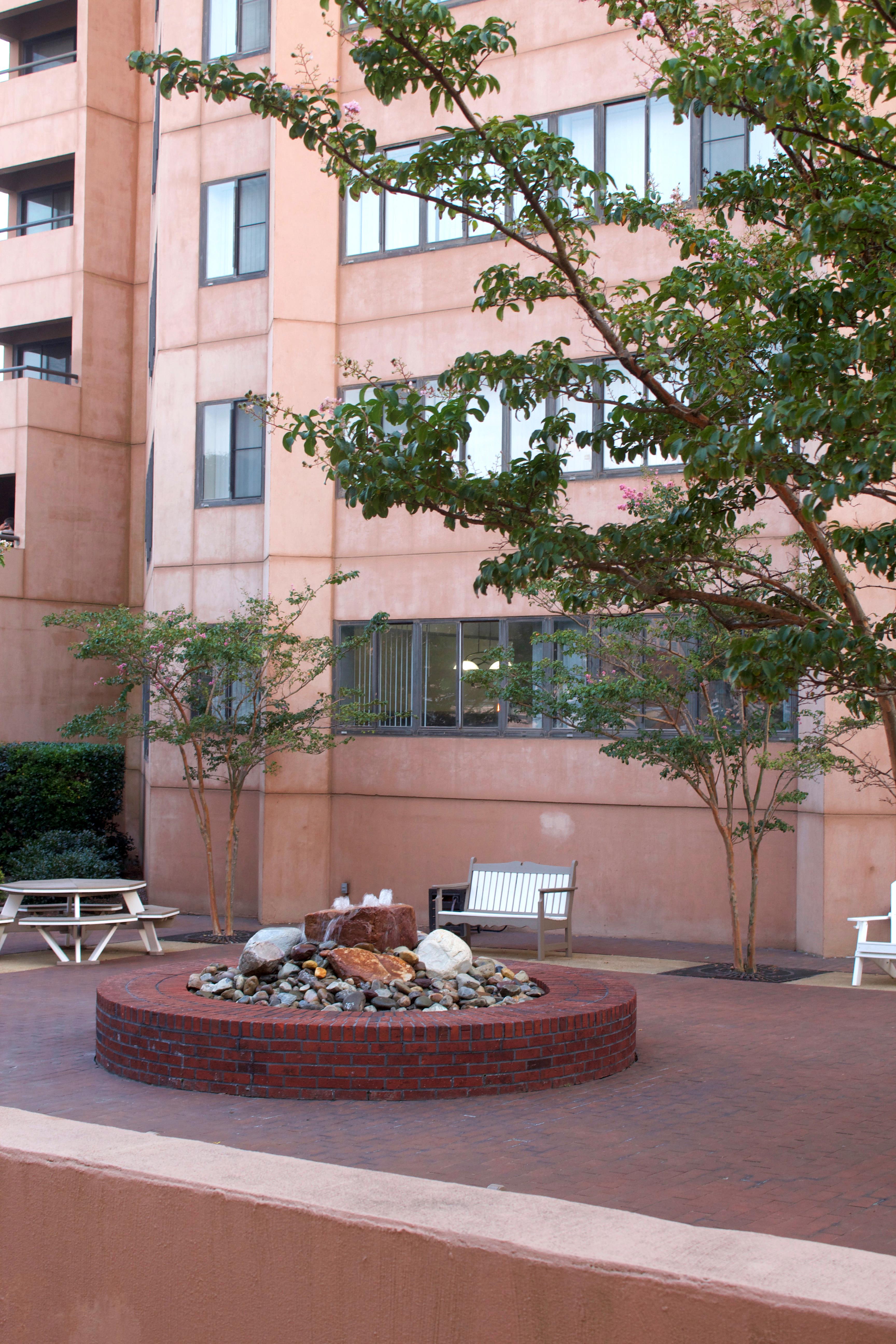 a fire pit in front of an apartment building