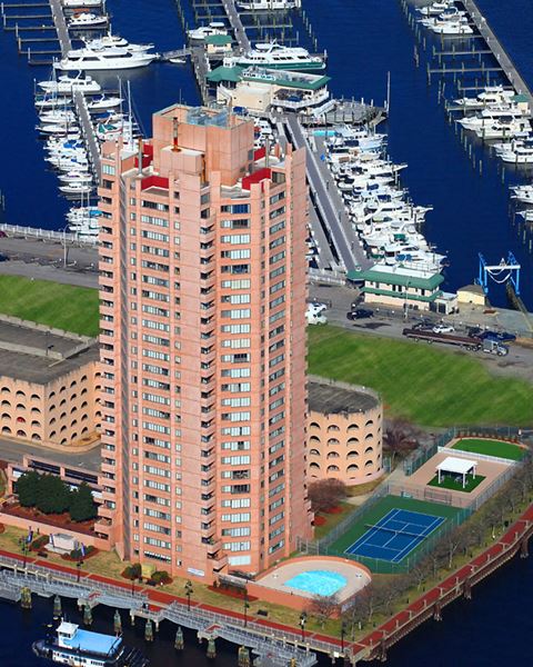 an aerial view of a building in front of a marina