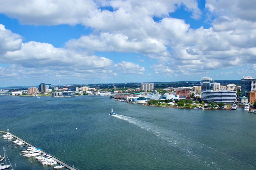 a view of the city and the water with a boat