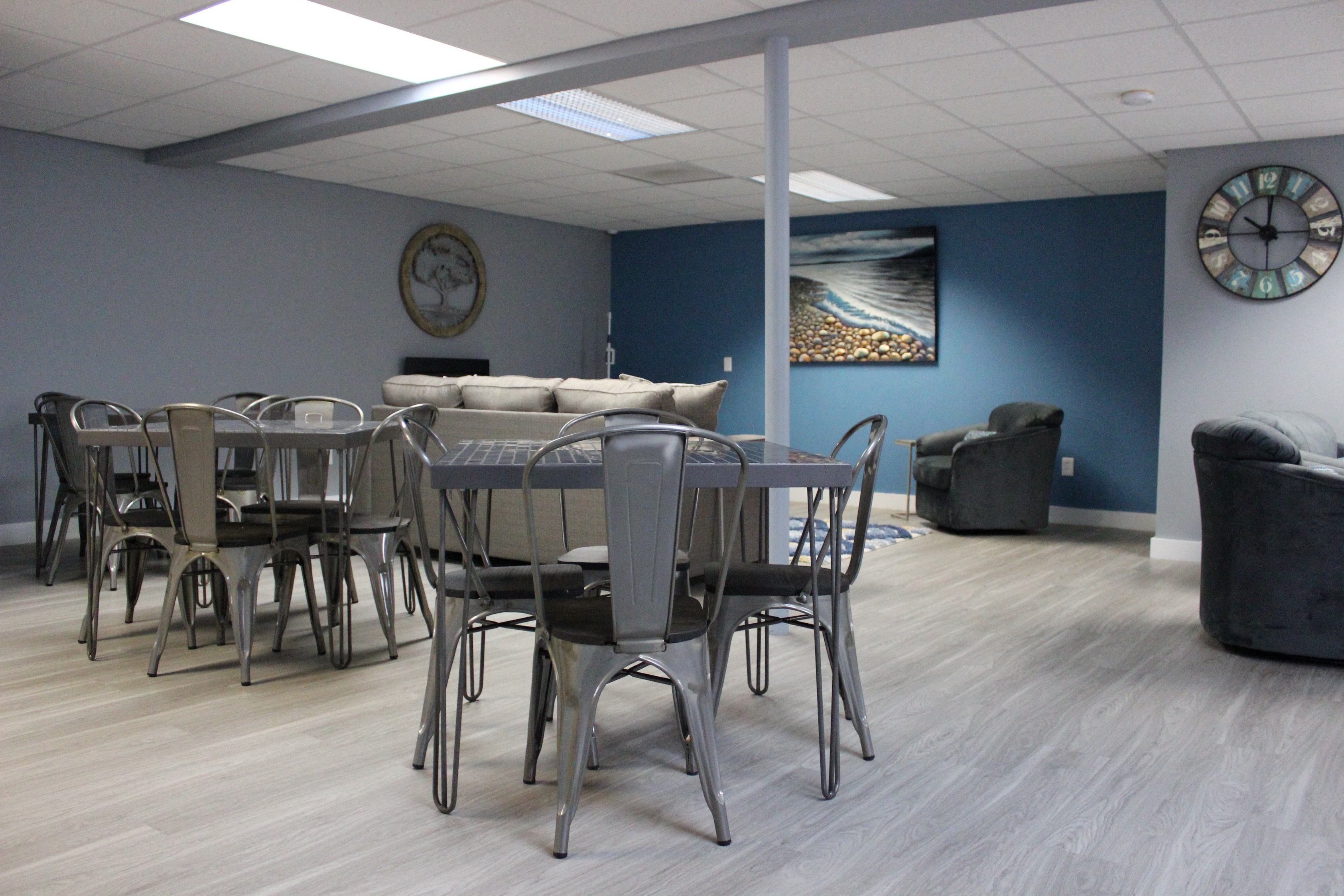 a dining room with tables and chairs and a clock on the wall