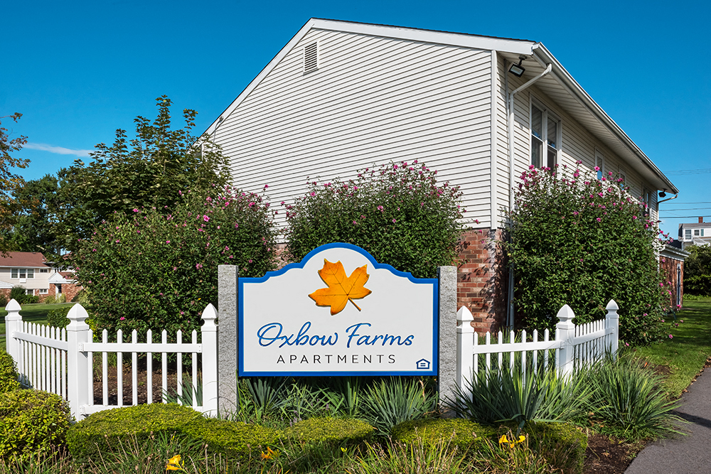 a white house with a sign for chicken farms apartments