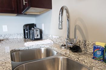 Granite countertops and large kitchen sink at 360 at Jordan West in West Des Moines, IA