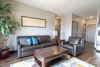 Comfy living room with hard wood flooring at 360 at Jordan West in West Des Moines, IA