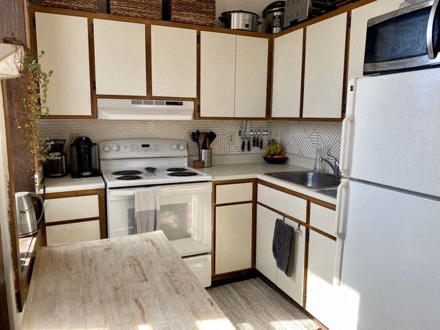 a kitchen with white appliances and wooden cabinets