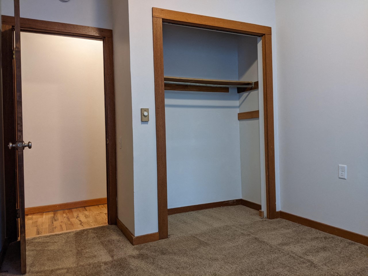 a room with a closet and an open door