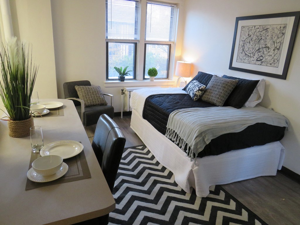 an example of a bedroom with a bed and a dining table
