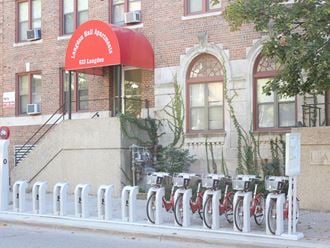 a row of bikes parked in front of a brick building