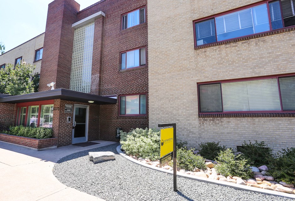 a brick building with a yellow sign in front of it