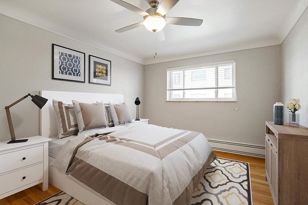 a bedroom with a bed and a ceiling fan