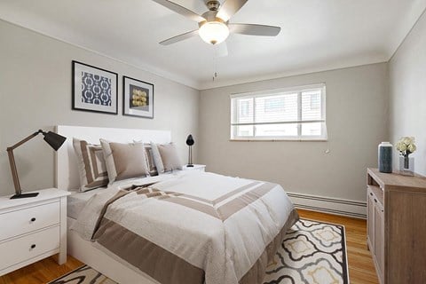a bedroom with a bed and a ceiling fan