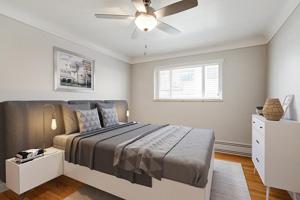 a bedroom with a bed and a ceiling fan