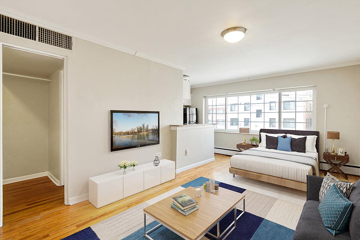 an open living room with a bed and a television