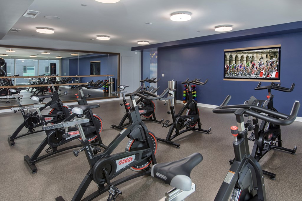 a spin class room with bikes and other exercise equipment in a gym