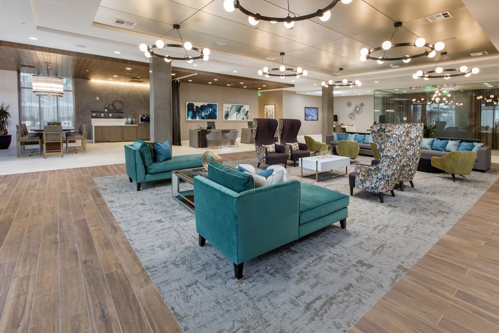 a living room with couches and chairs in a lobby