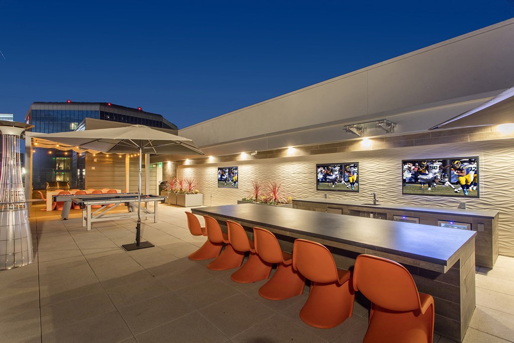 a bar and ping pong table on the patio of a house