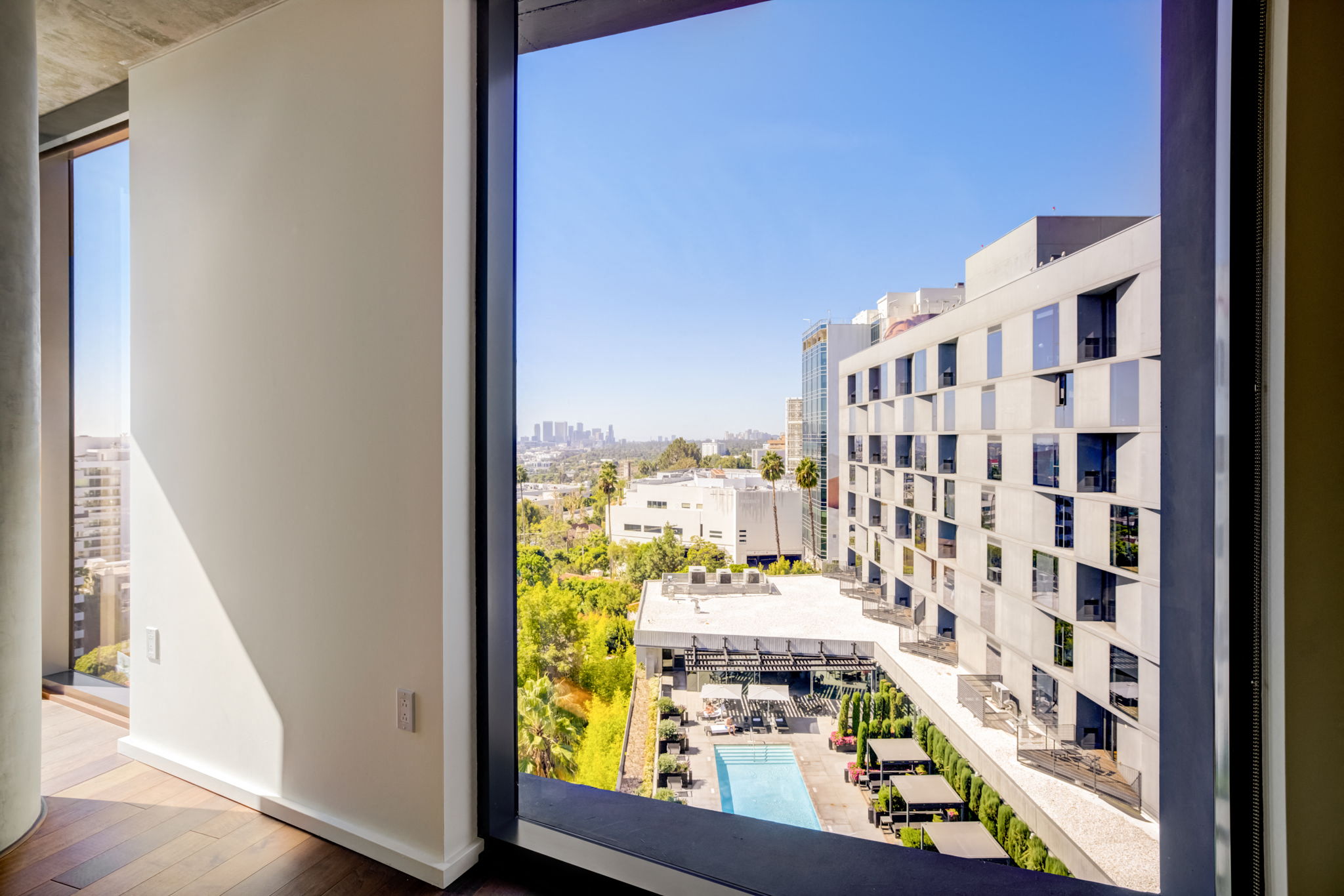 a view of the city from a window of an apartment building
