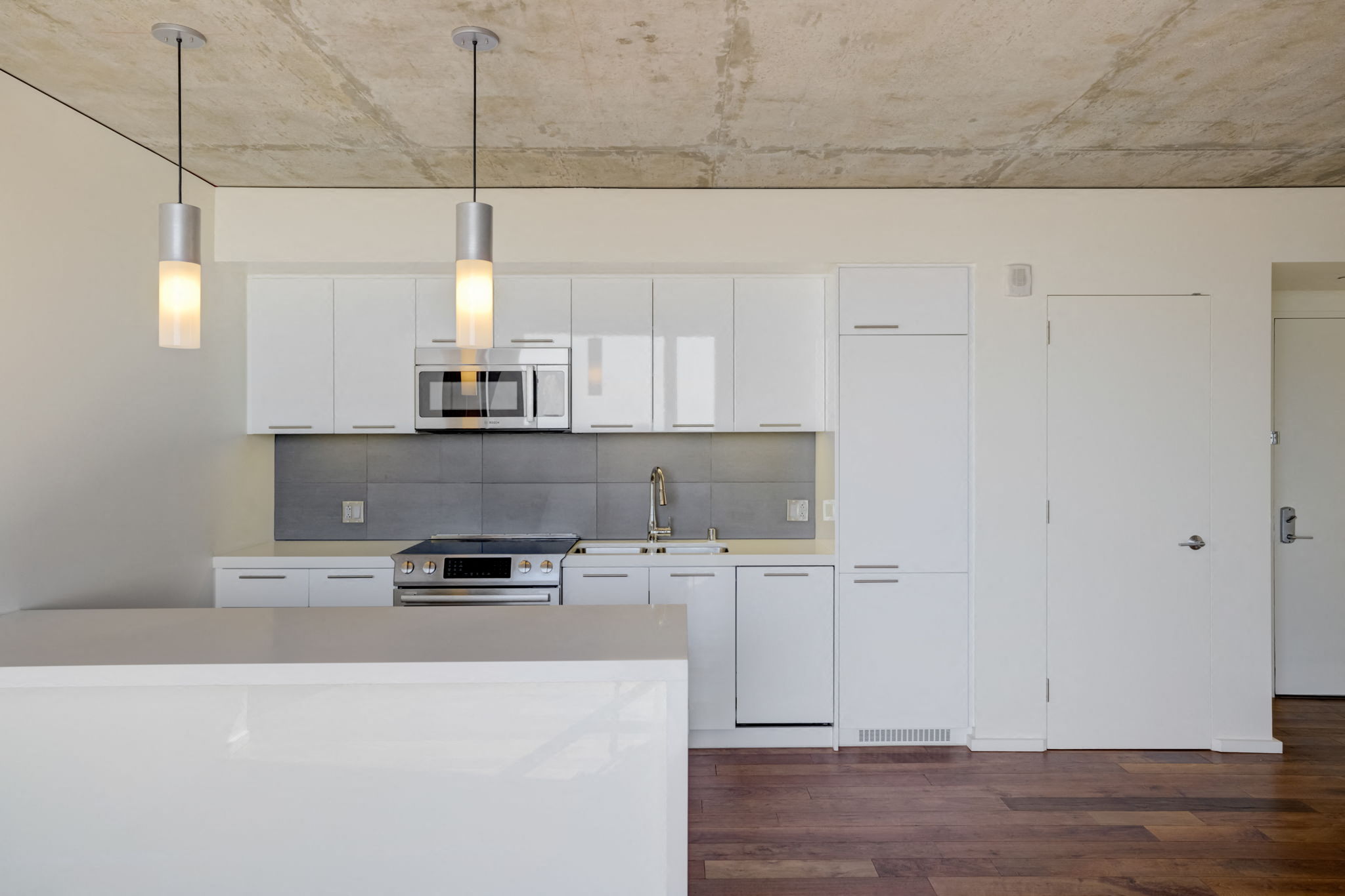 a kitchen with white cabinets and a white counter top