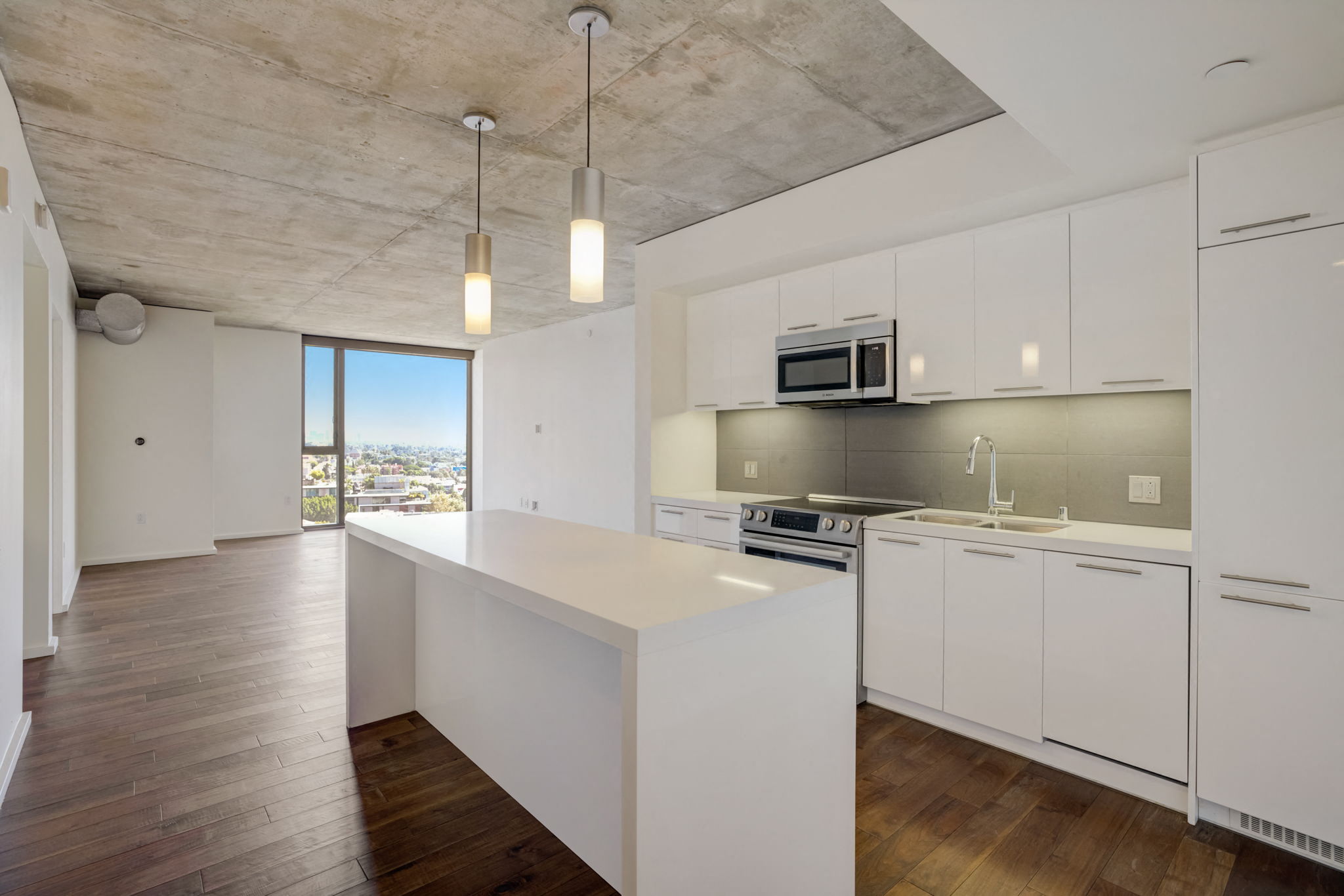 a kitchen with white cabinets and a white counter top
