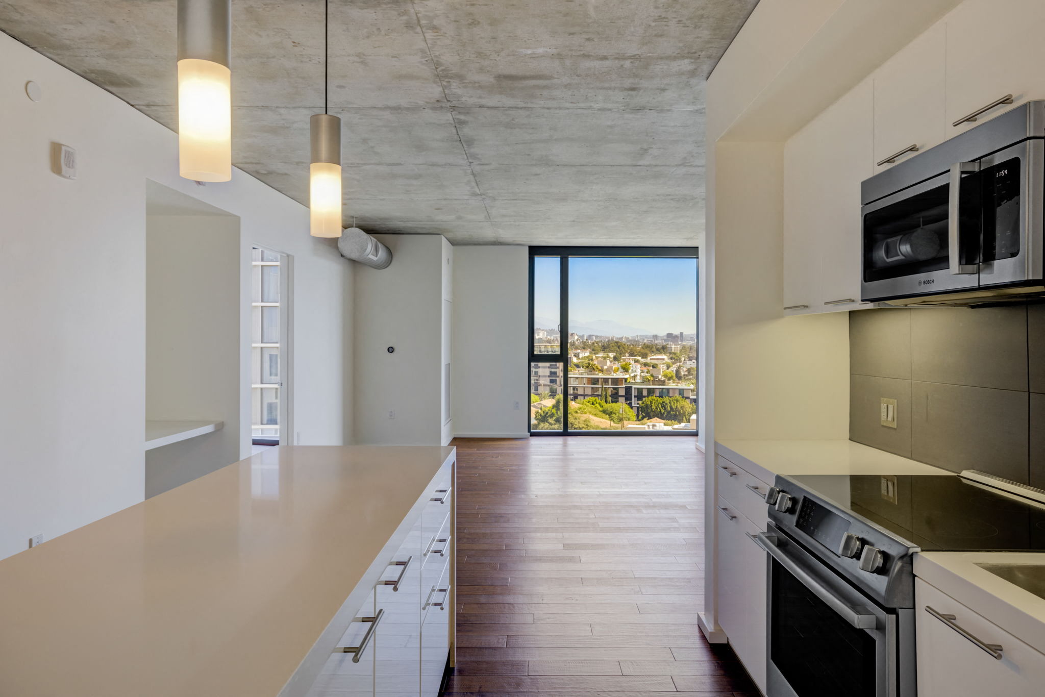 a kitchen with a large island and a view of the city