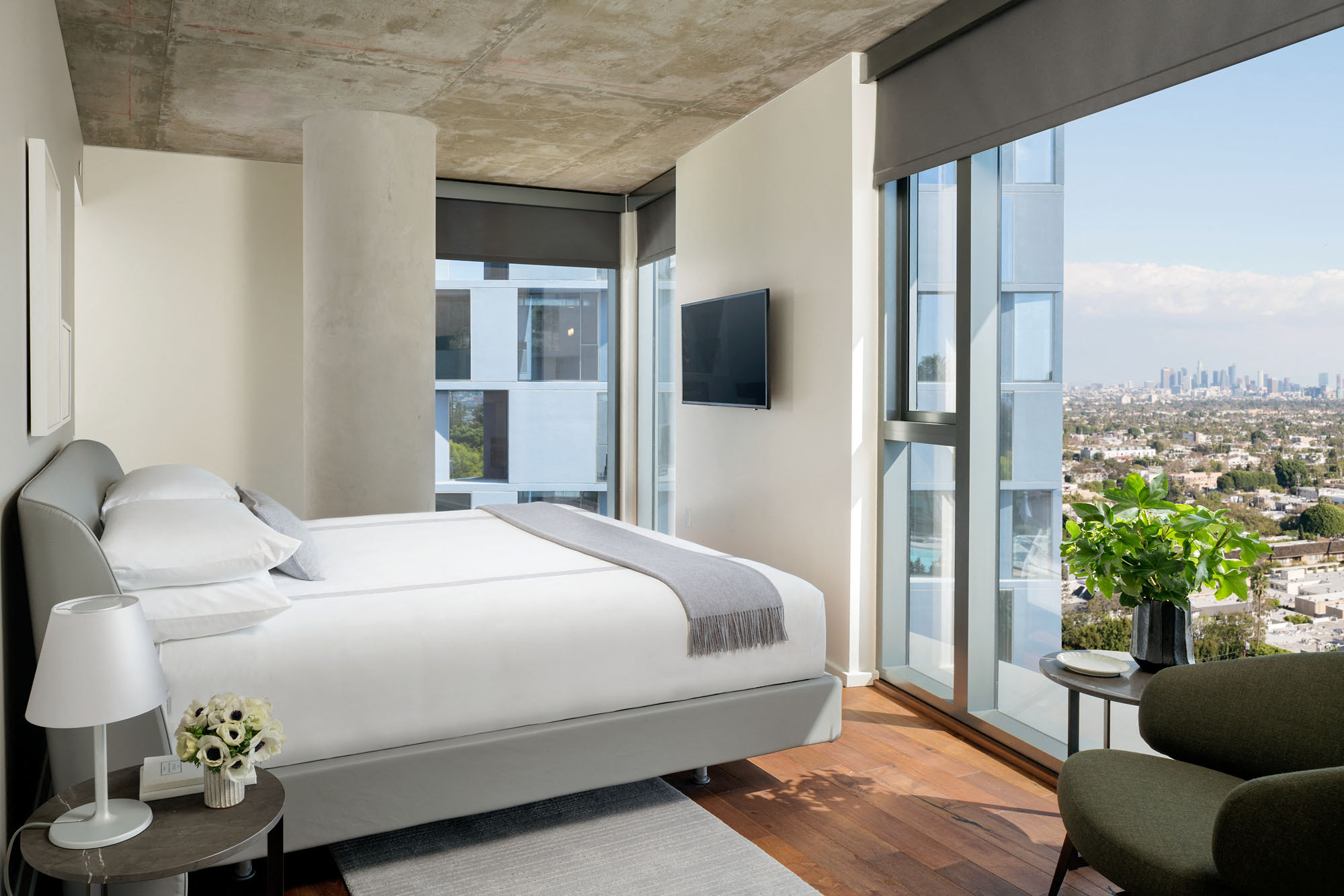 a hotel room with a bed and a view of the city