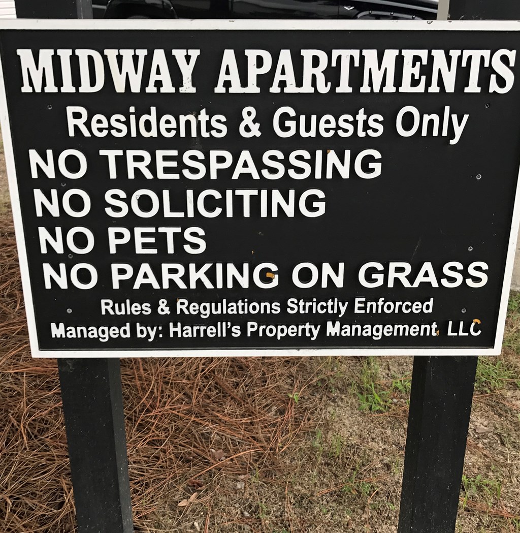 a sign that says midway apartments residents only no trespassing no solicitation no pets