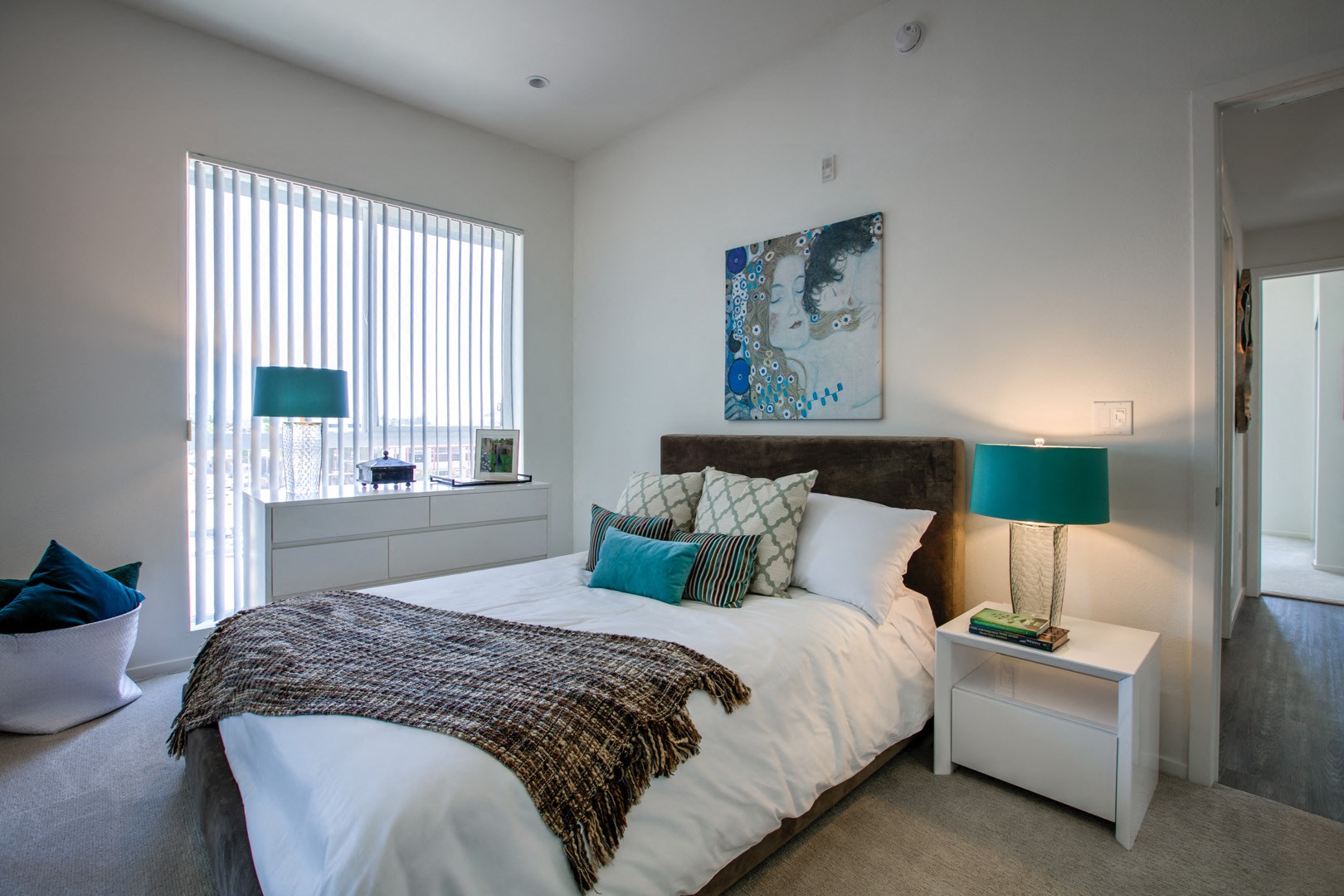 a bedroom with a large bed and a window