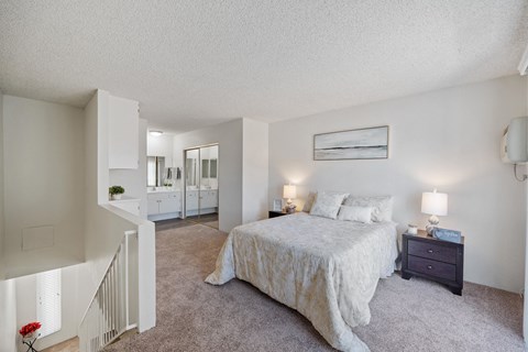 a bedroom with a bed and a staircase