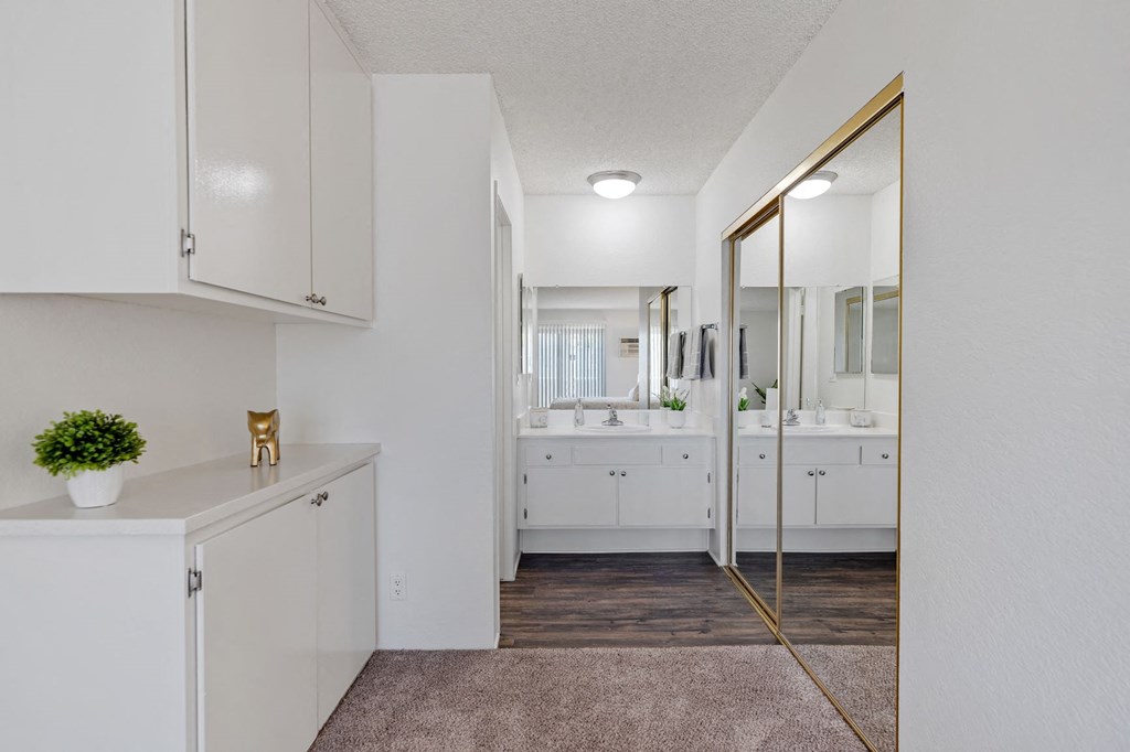 a white bathroom with a mirror and a sink