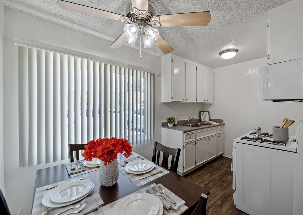 a kitchen and dining room with a table and a ceiling fan