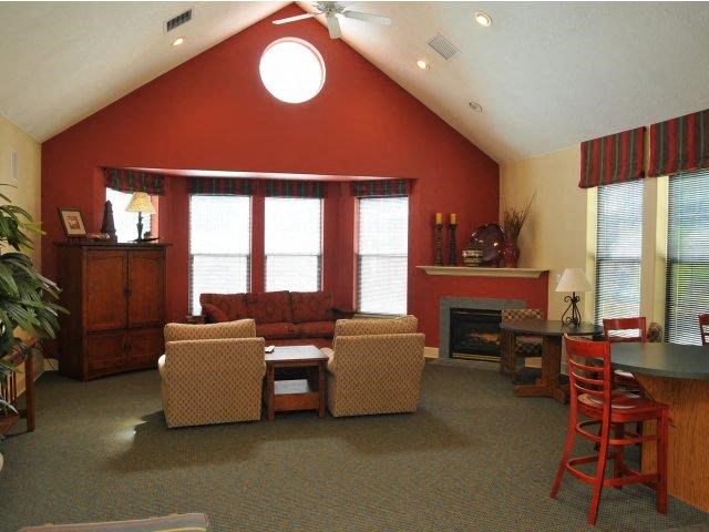 a living room with a couch and chairs and a table
