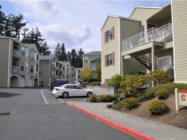 an apartment building with cars parked in front of it