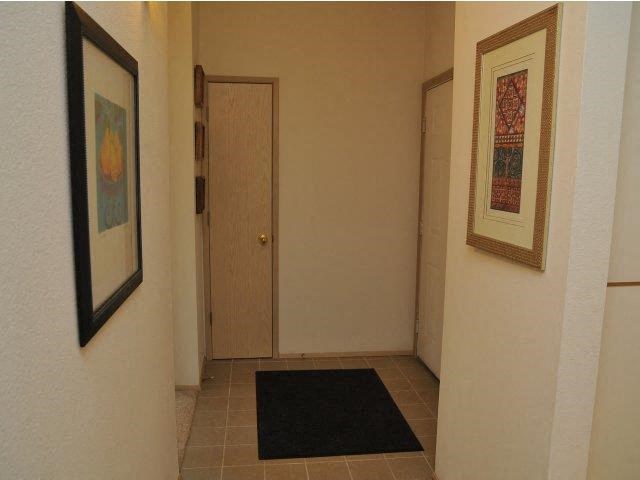 a hallway with a black rug and a door