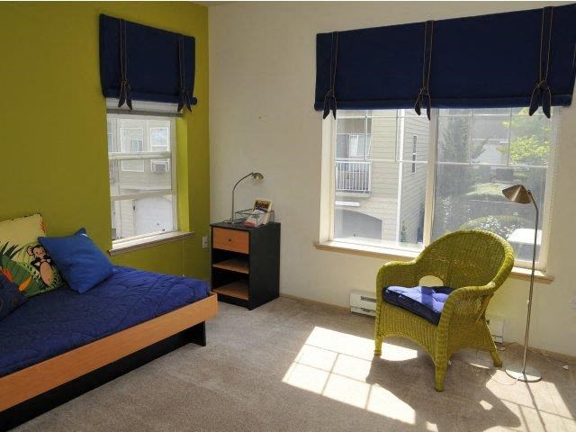 a small room with a bed and a chair