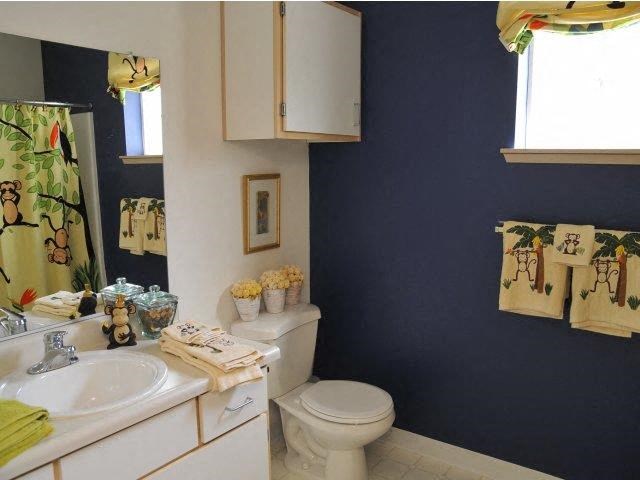 a bathroom with a toilet and a sink and a mirror