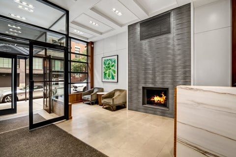 a living room with a fireplace and a glass door
