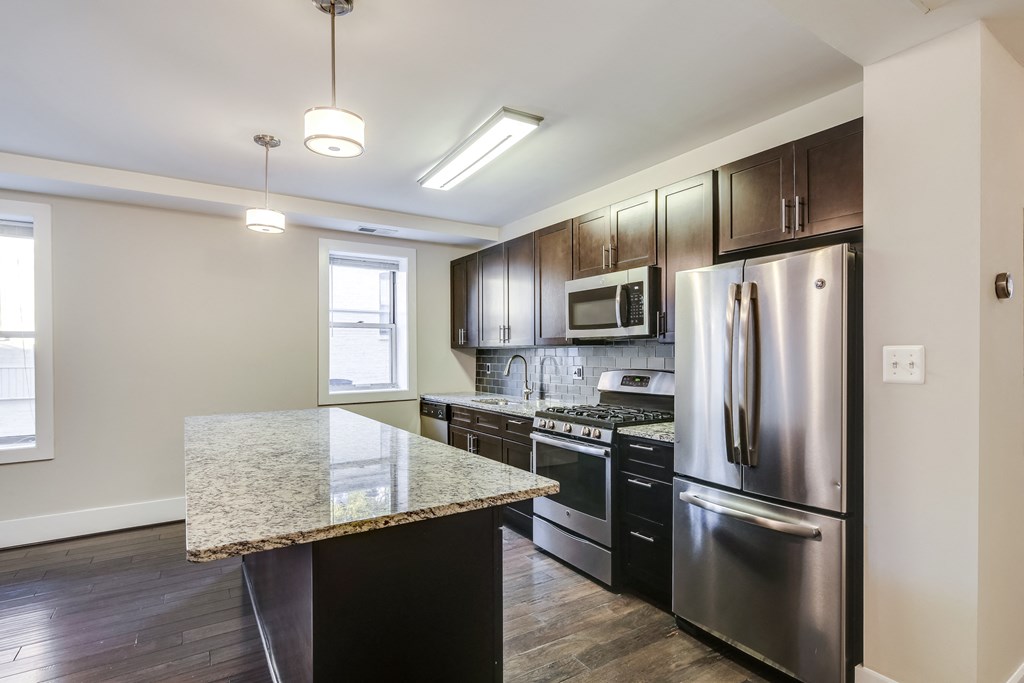 a kitchen with stainless steel appliances and a granite counter top