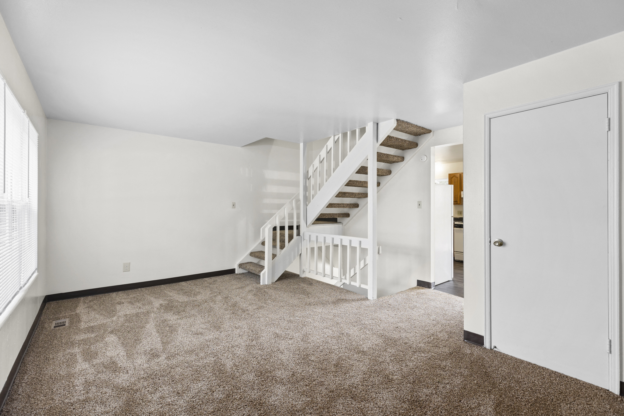 Living space with stairway access at Stonebridge Townhomes