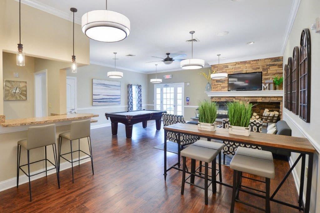 a living room with a bar and a pool table