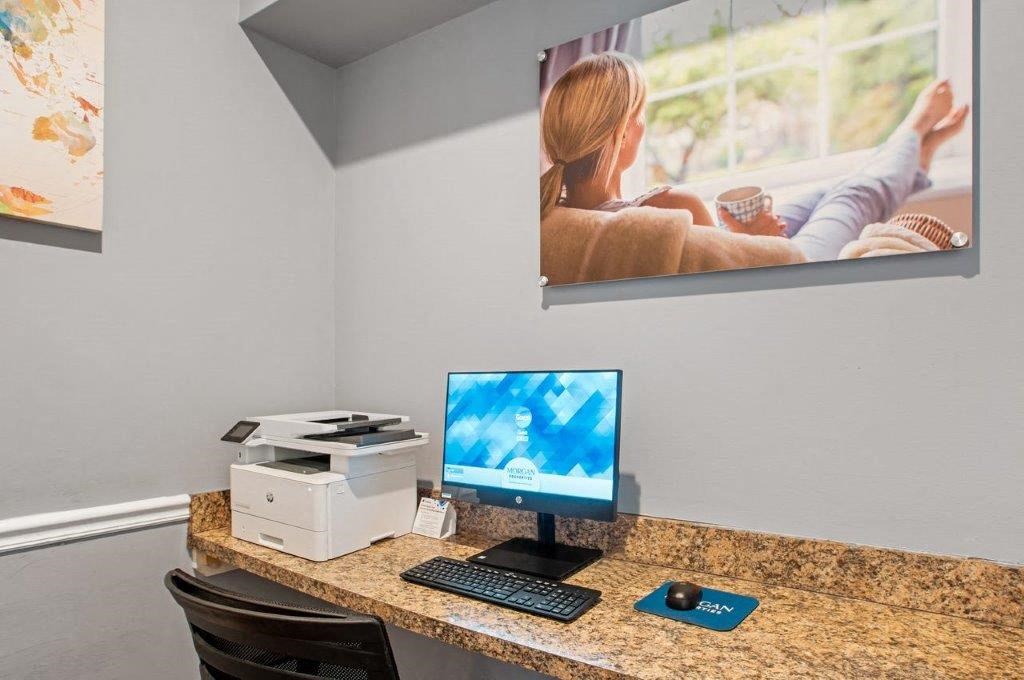 a computer desk with a monitor and a keyboard and mouse