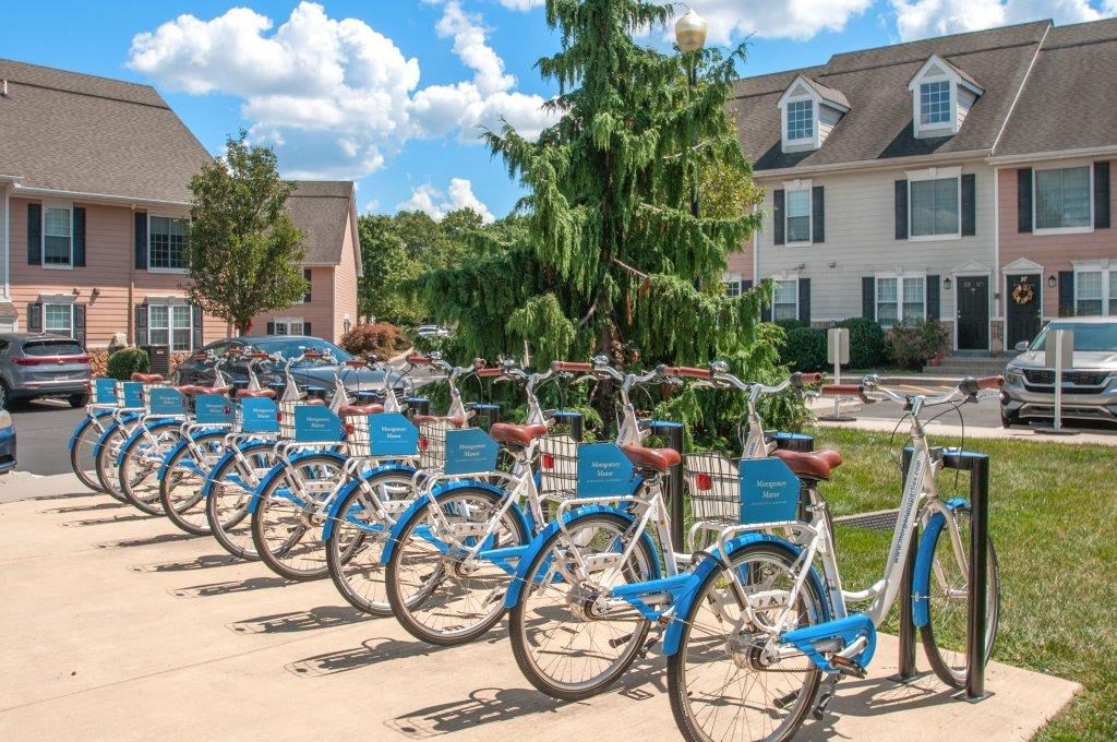 a row of blue bikes parked in a parking lot