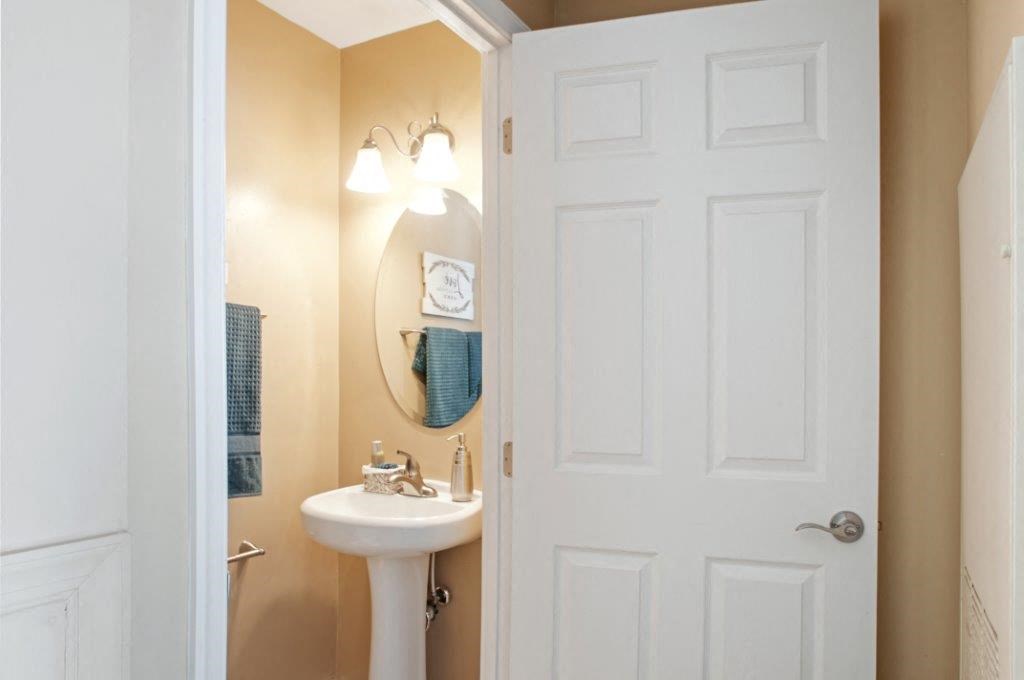 a bathroom with a sink and a white door