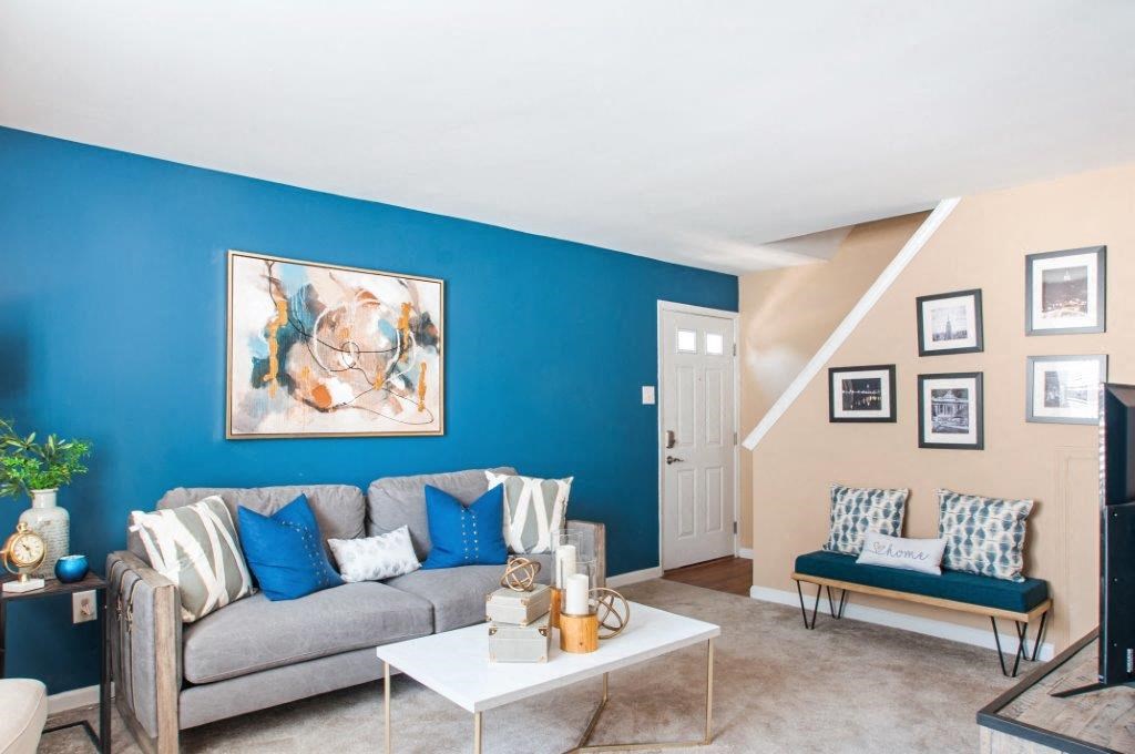 a living room with a blue wall and a couch
