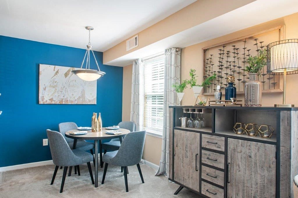 a dining room with a table and chairs